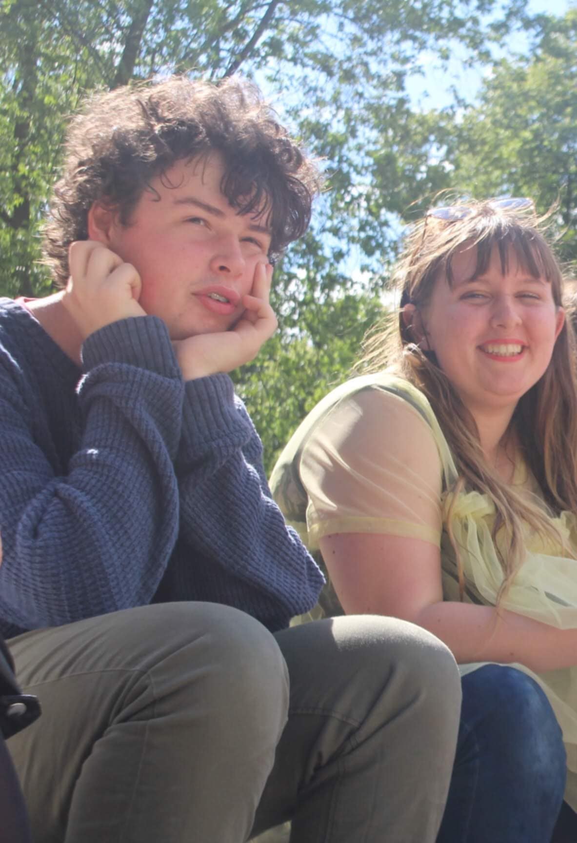 A picture of Finn and Rhianna as sixth-formers sitting next to each other in the sunshine